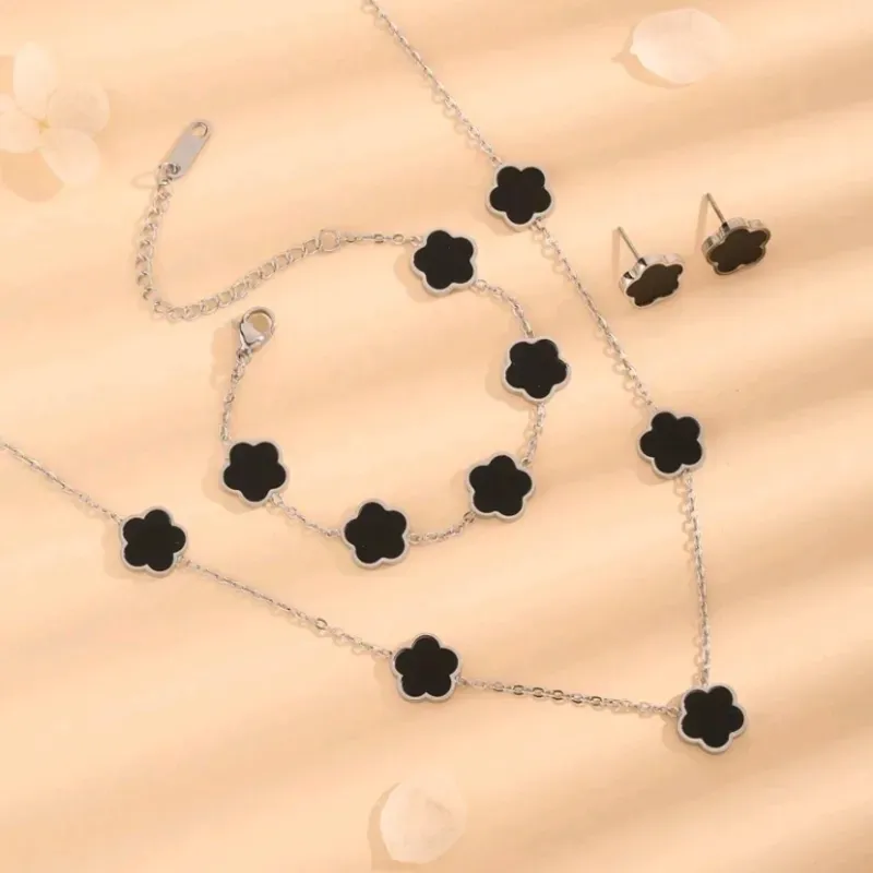 Juego de collar , pulsera y pendientes de acero inoxidable 