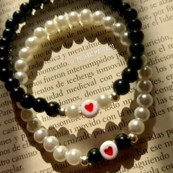 pulseras blancas y negras con corazon y balin dorado🔆