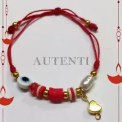 Ojo turco de hilo sencillo con piedra  de rio y fimo plano 