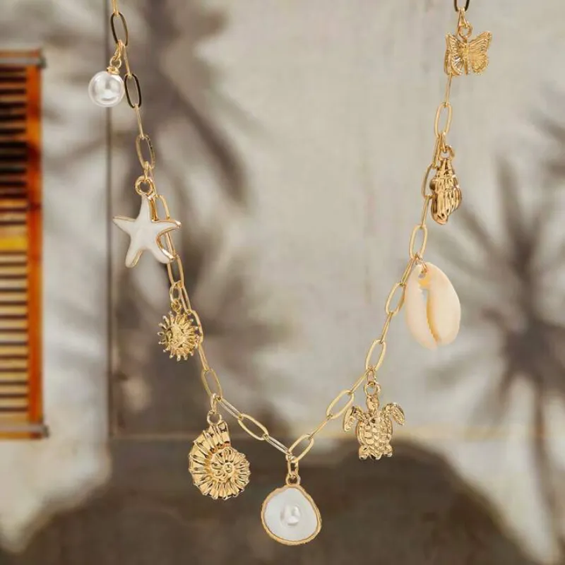 Colgante dorado concha con perla 