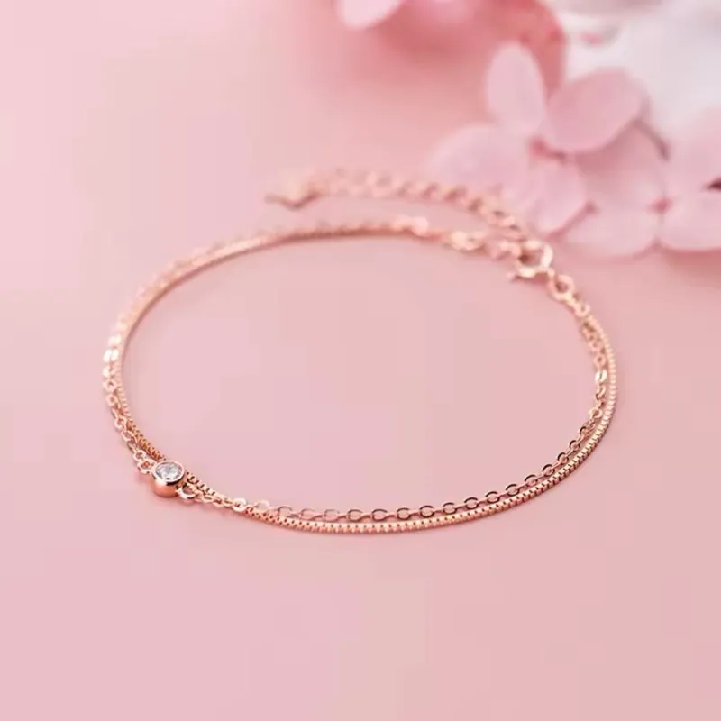 Pulsera doble de oro rosa con piedra central