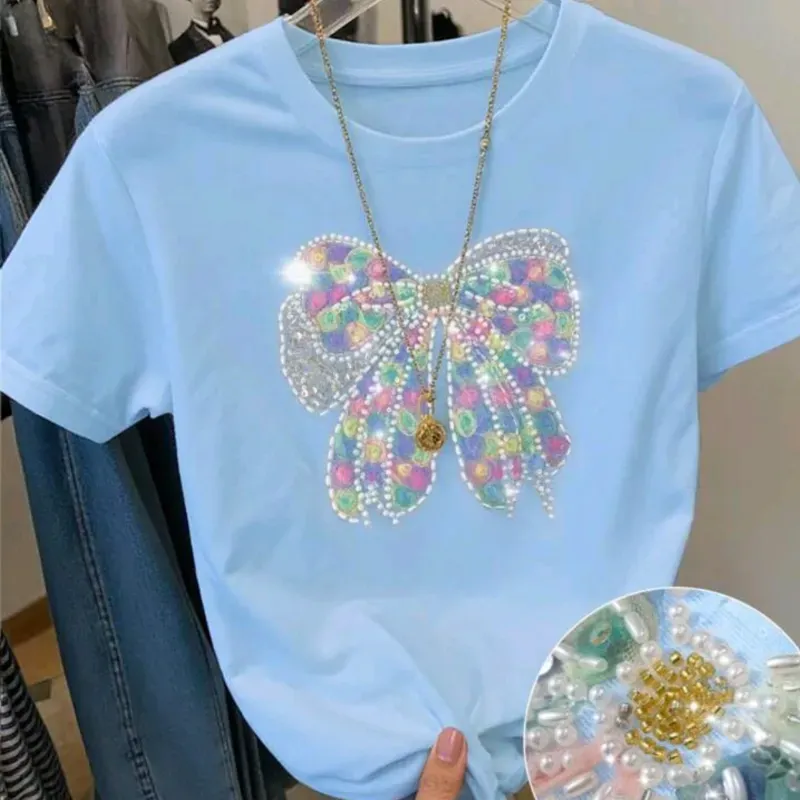 Camiseta azul lazo con pedrería 