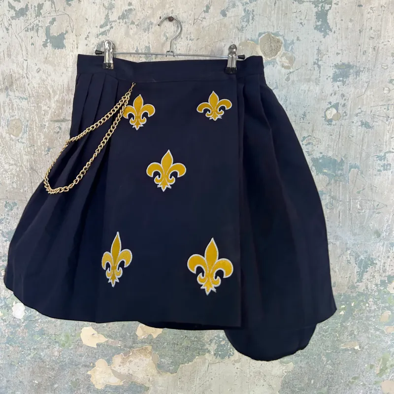 Saya de tachones con flor de lis
