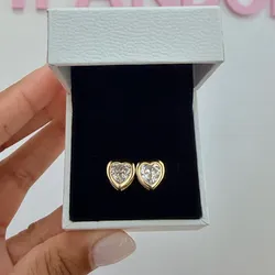 Aretes de corazón con borde dorado grande